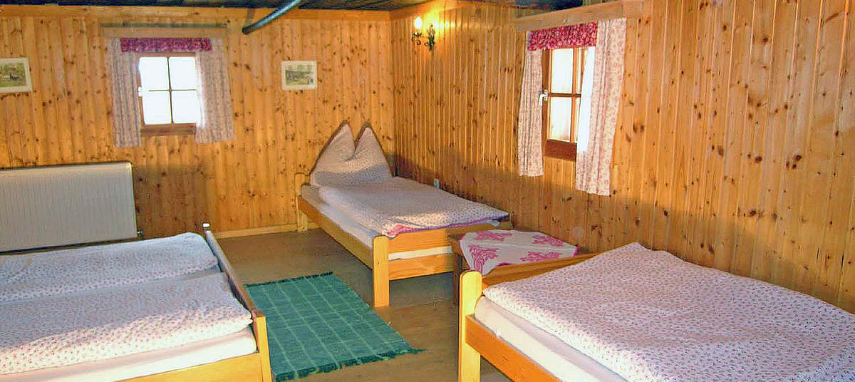 Zimmer mit Doppelbett und zwei Einzelbetten