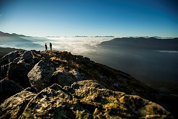 Ein Paar genießt die Aussicht nach dem Aufstieg auf den Gipfel